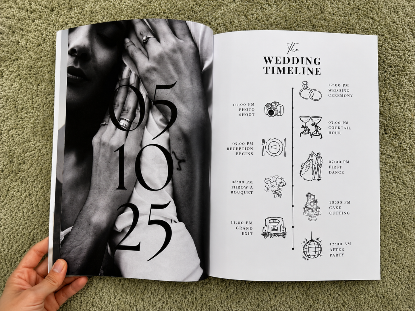 An open wedding timeline planner or book held by a hand, showing a black-and-white close-up photo on the left page and a timeline titled 'The Wedding Timeline' on the right page, placed on a green textured surface.