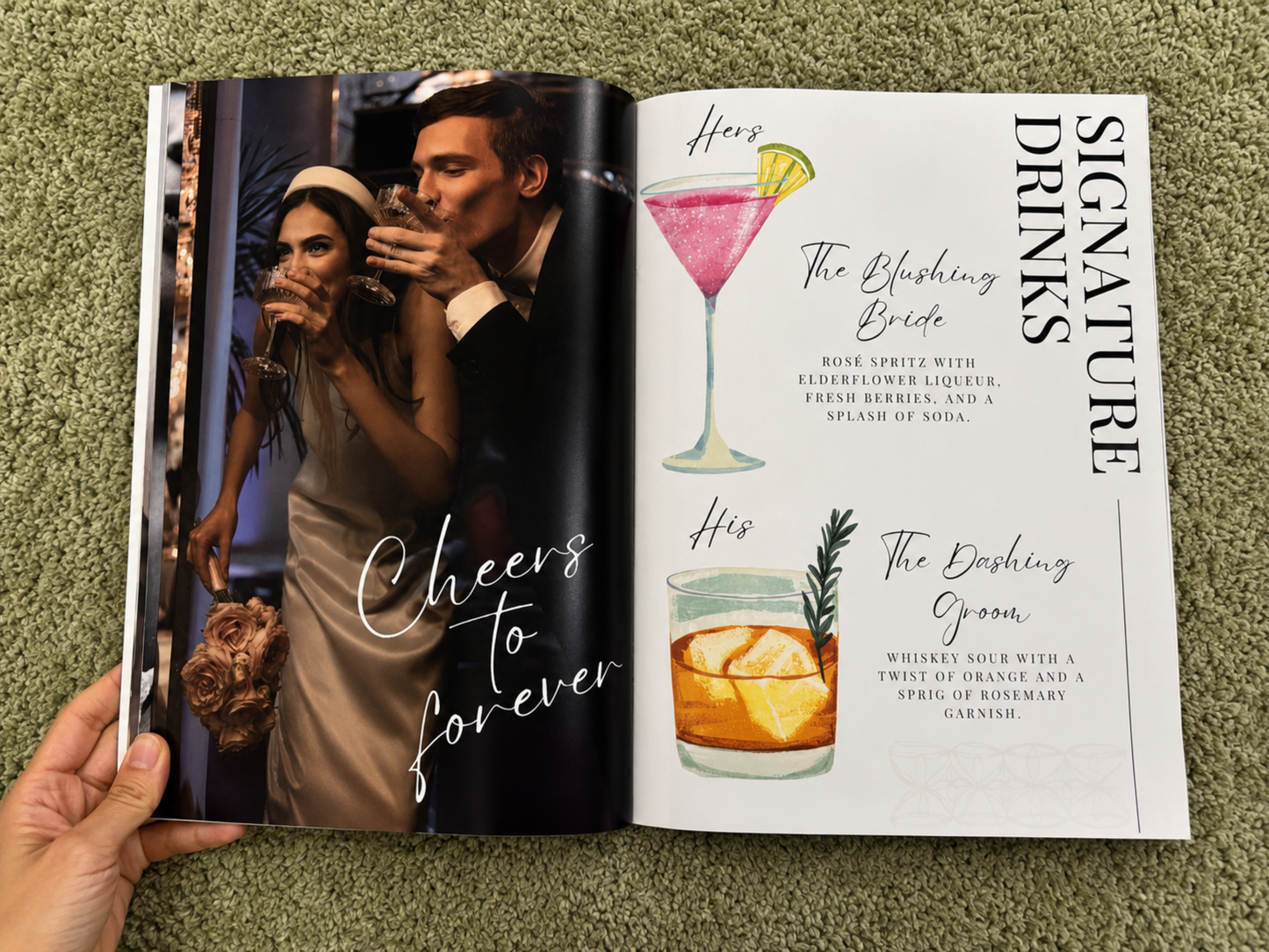 An open magazine or book spread laid on a green textured surface, showing a wedding-themed cocktail guide with a photo of a couple on one page and illustrations and text for signature drinks on the other. A hand is holding the left page.